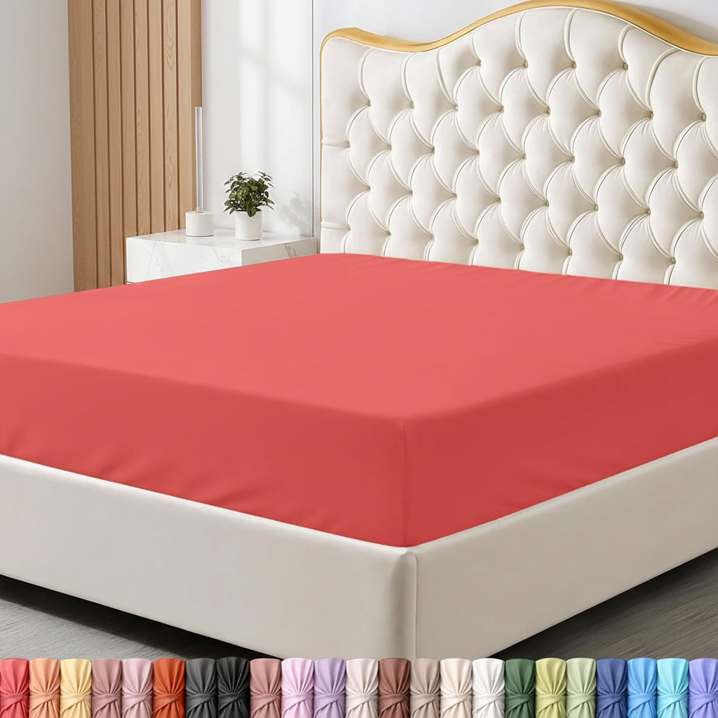 Red fitted sheet on a bed with a headboard and nightstand in a bedroom setting.