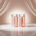 Two bottles of Bio-Oil 200ml specialized skincare oil with white caps, shown side-by-side against a white background, with two product boxes behind them.