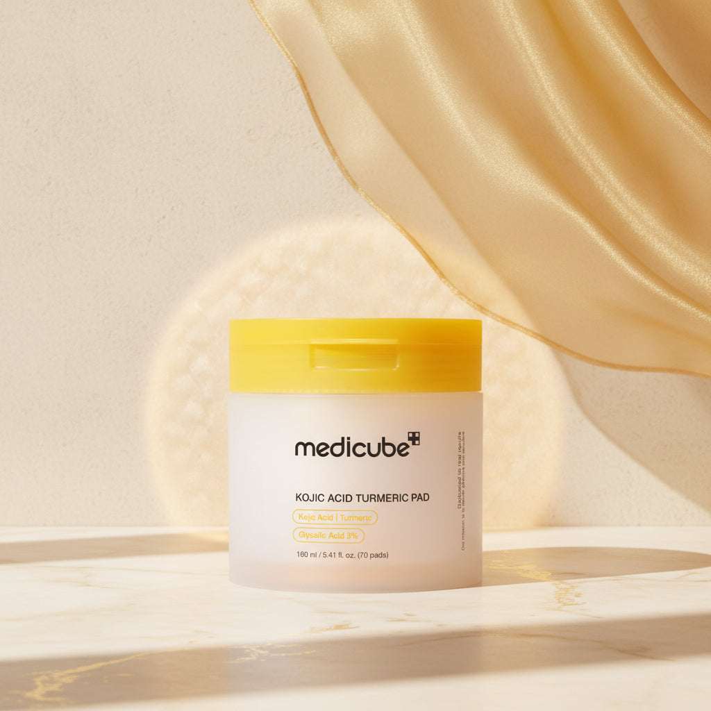 Medicube Kojic Acid Turmeric Pad packaging with yellow lid on a beige background