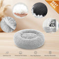 A plush round pet bed in light gray faux fur, shown on a white background with circular detail insets highlighting the fluffy texture, dotted non-slip bottom, soft lining, and fabric texture. Text at the bottom lists features including soft faux fur, premium PP cotton, non-slip bottom, and machine washable.