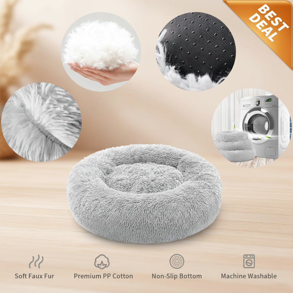 A plush round pet bed in light gray faux fur, shown on a white background with circular detail insets highlighting the fluffy texture, dotted non-slip bottom, soft lining, and fabric texture. Text at the bottom lists features including soft faux fur, premium PP cotton, non-slip bottom, and machine washable.