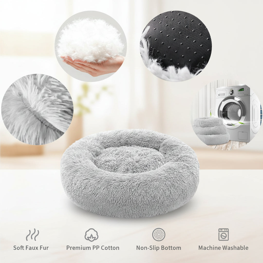 A plush round pet bed in light gray faux fur, shown on a white background with circular detail insets highlighting the fluffy texture, dotted non-slip bottom, soft lining, and fabric texture. Text at the bottom lists features including soft faux fur, premium PP cotton, non-slip bottom, and machine washable.