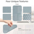 Set of four textured silicone mats with front and back views showing different patterns and suction cup design.