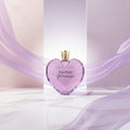 Vera Wang Princess perfume bottle with a heart shape and gold crown on a white background