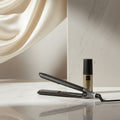 Woman with styled hair next to a hair straightener and bottle, with text in Italian about their bestseller product.