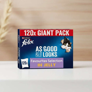 Purina Felix 120x Giant Pack box for Favourites Selection In Jelly cat litter. The packaging features a dark blue background with a red banner at the top, white text, and a cartoon cat peeking out from a cardboard tube on the right.