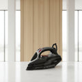 Black steam iron with red accents on a white background