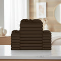A stack of dark brown folded bedding pieces, likely sheets or duvet covers, arranged in a tiered stack against a plain white background.