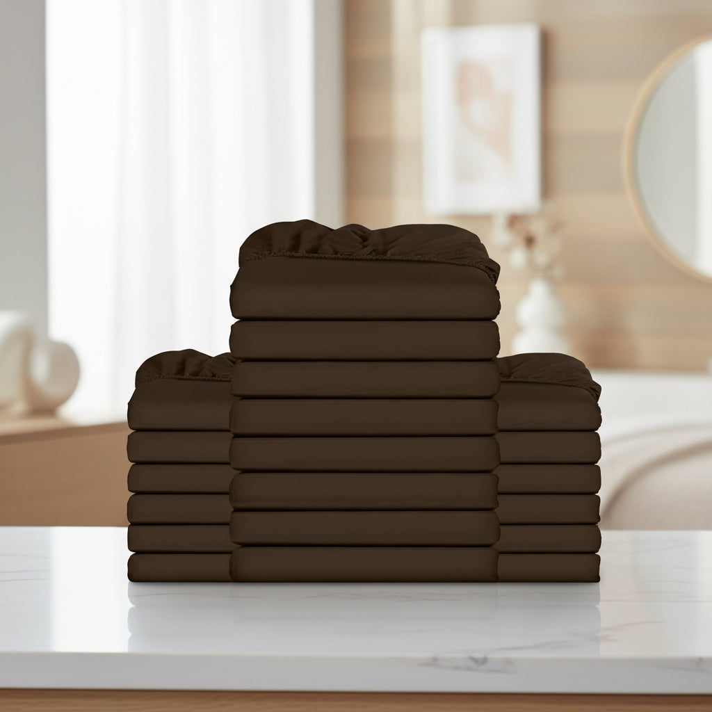 A stack of dark brown folded bedding pieces, likely sheets or duvet covers, arranged in a tiered stack against a plain white background.