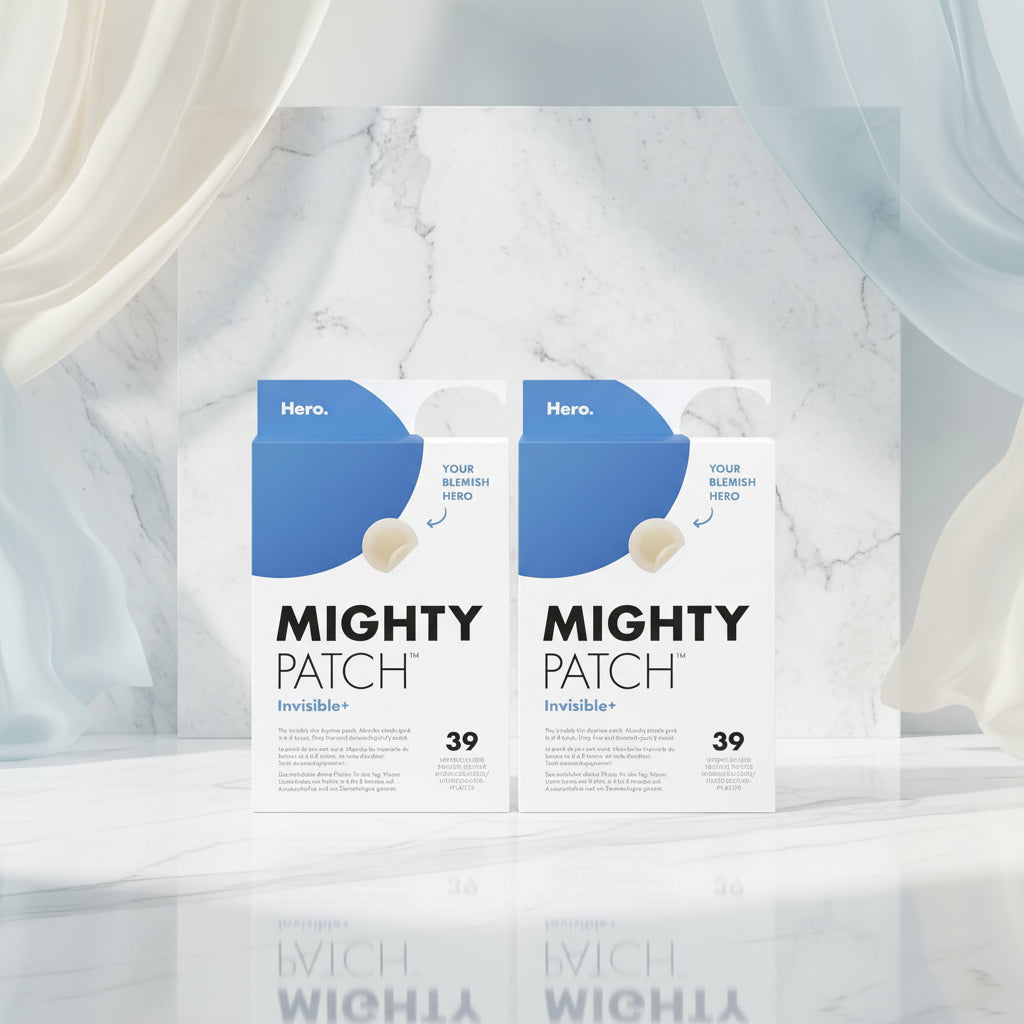 Two identical boxes of Mighty Patch Invisible+ hydrocolloid ankle patches shown side by side on a white background. The packaging features a blue top section with a white lower section, bold black text, and a small beige patch illustration.
