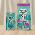Barking Heads pet food packages on a light blue background with promotional text.