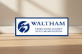 Waltham logo banner with a blue circular dog silhouette icon and the text 'WALTHAM' and 'A WORLD LEADING AUTHORITY ON PET CARE AND NUTRITION' on a white background with a blue border.