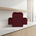 Stack of burgundy folded towels on a white background