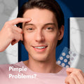 Man holding a clear face mask with text 'Pimple Problems?' against a blue background