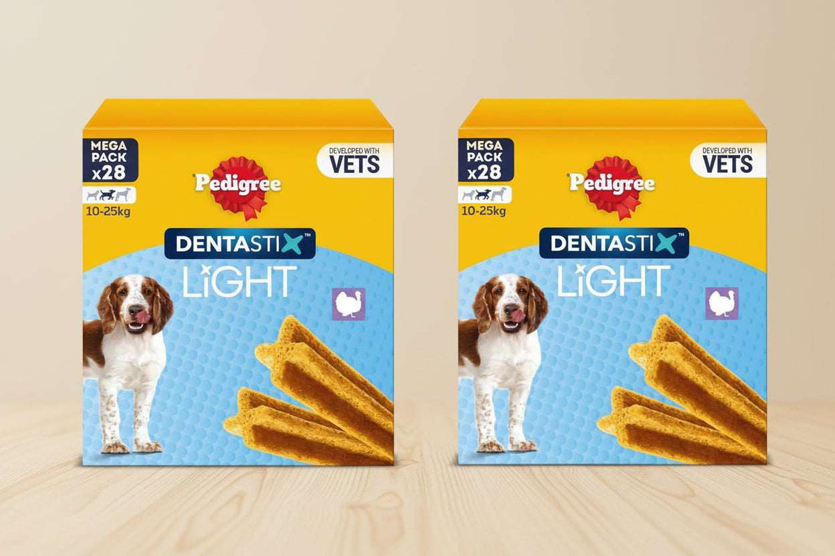 Two boxes of Pedigree Dentastix Light dog treats with visible branding and product details.