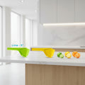 Three citrus juicers in green, yellow, and orange with corresponding fruit illustrations on a white background.