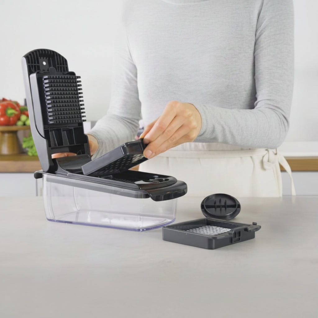 Person using a kitchen chopper with 'fullstar' branding on a kitchen counter.