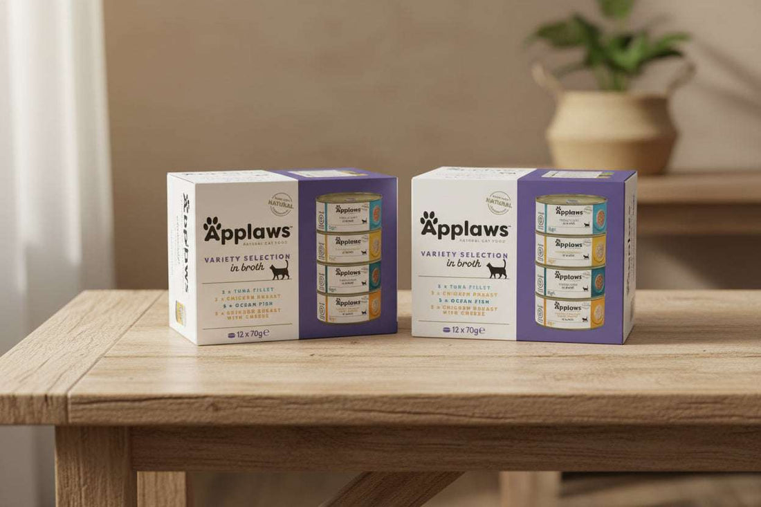 Box of Applaws natural cat food variety selection in broth with cans displayed.