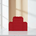 A stack of folded red bedding, including sheets or duvet covers, arranged symmetrically against a plain white background.