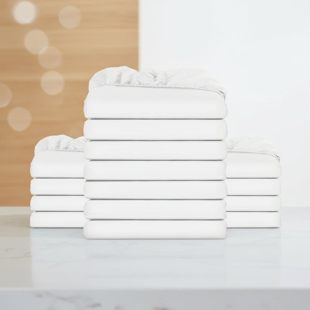 A stack of folded white bedding, likely sheets or a bedding set, shown against a plain white background.