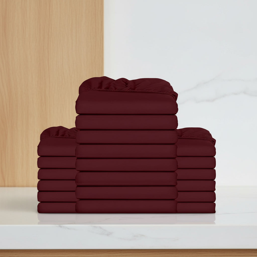 Stack of burgundy folded towels on a white background