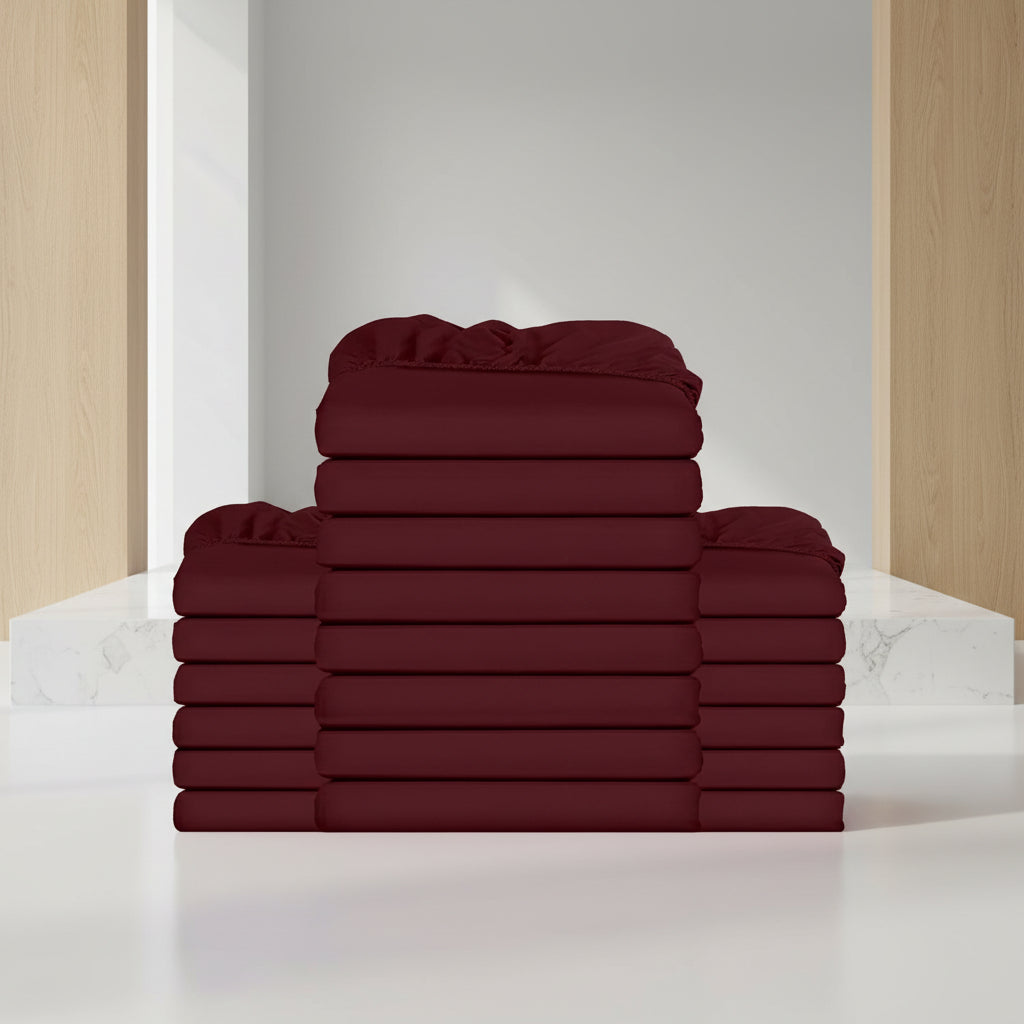 Stack of burgundy folded towels on a white background