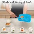 Blue silicone mat with food residue on a kitchen counter, text 'Works with Variety of Foods' above.
