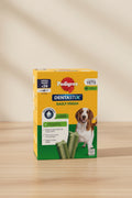 A box of Pedigree DentastiX Daily Fresh dog dental care, Mega Pack x28, featuring a yellow and green packaging design with a brown and white dog on the front.