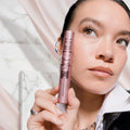 Woman holding a pink mascara with text about lash impact and product features.