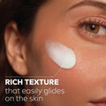 Close-up of a woman's face with a product applied, labeled 'Rich Texture that easily glides on the skin'.