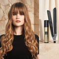 A woman with long, wavy light brown hair is shown on the left, while the right side displays a black hair styling tool and a gold-and-black bottle labeled dhi, with Italian promotional text.