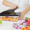 Person using a food processor with vegetables on a white background, featuring the 'fullstar' brand.