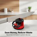 Red and black knife sharpener on a kitchen counter with text 'Save Money, Reduce Waste'.