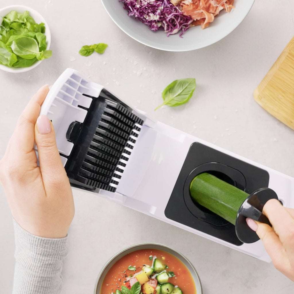 Person using a vegetable slicer with a 'fullstar' logo in the corner.