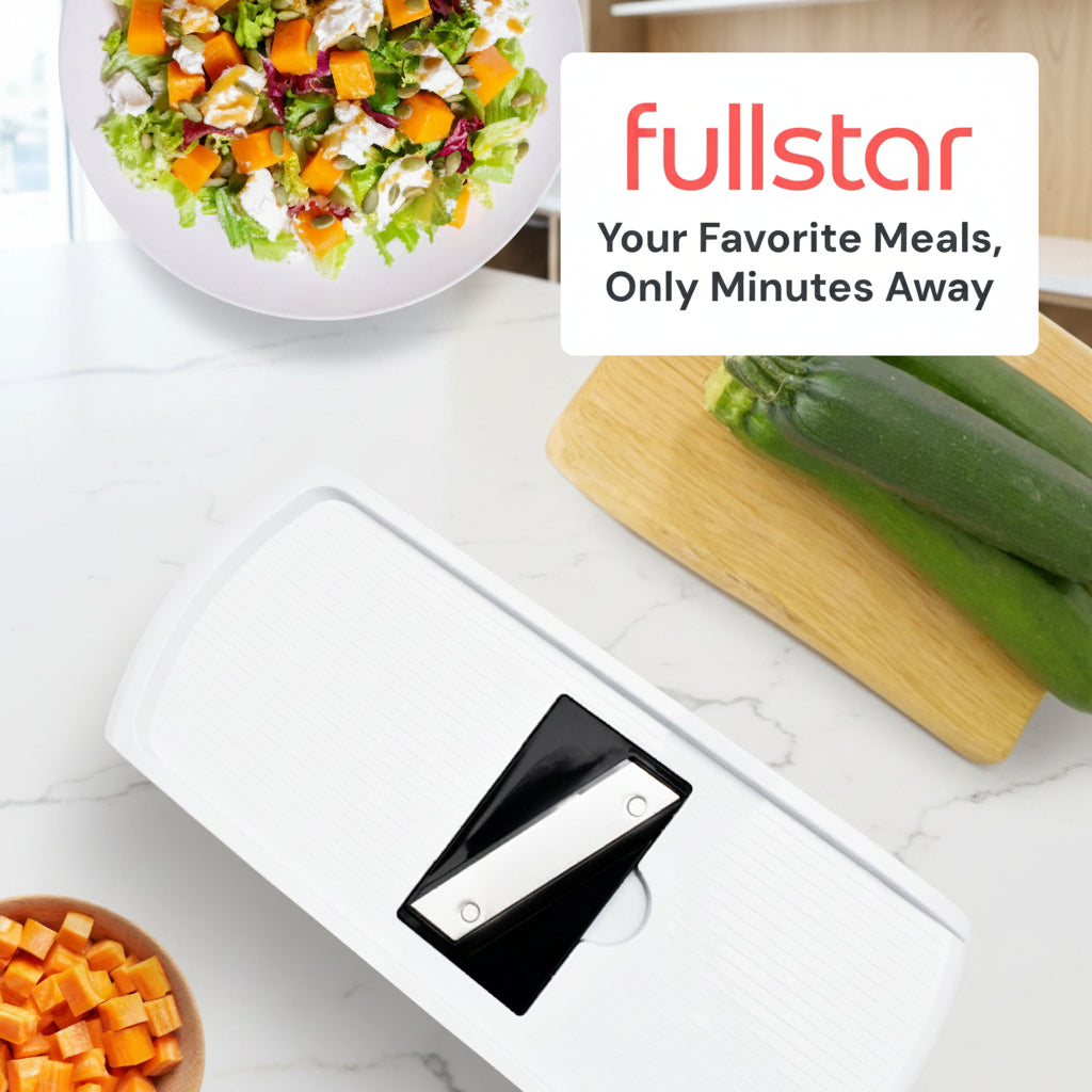 White kitchen appliance with black component on a table with vegetables and salad, featuring 'fullstar' branding.