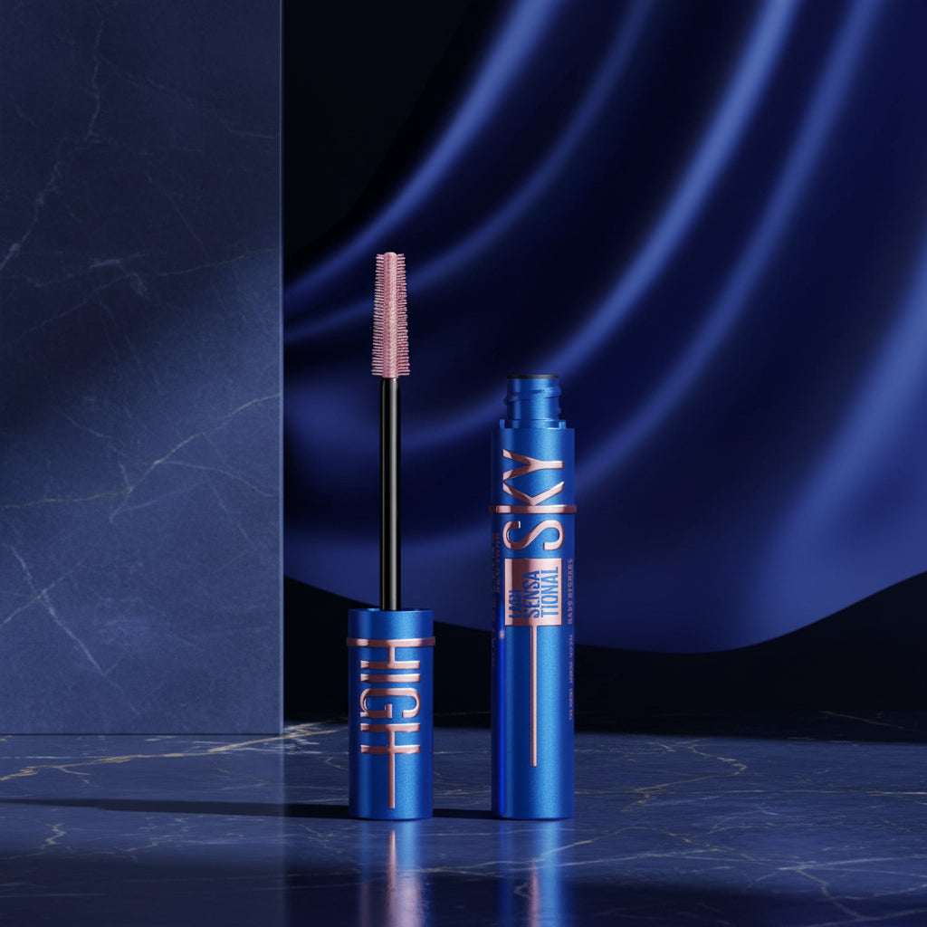 Blue mascara tube and wand with a blue makeup smear behind it on a white background. The tube shows the text 'HIGH SKY' and 'SEAMLESS DEFINING'.