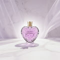 Vera Wang Princess perfume bottle surrounded by flowers with notes listed