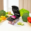 Vegetable chopper with a 1.2L family size tray on a white background with vegetables around.