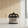 A cylindrical sharpening stone holder with a black handle and base, featuring a gray and white marble-patterned body with gold veining and the text 'Any Sharp' printed on the front.