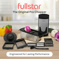Fullstar Pro Chopper set on a kitchen counter with various attachments and vegetables.