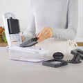 Person using a kitchen chopper with 'fullstar' branding on a kitchen counter.