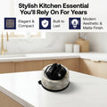 A kitchen drawer organizer tray made of light natural wood with multiple compartments, holding gold-toned utensils and a round black-and-white marble-and-stone holder. Text at the top reads 'Stylish Kitchen Essential You'll Rely On For Years' with feature callouts: Elegant & Compact, Built to Last, and Modern Aesthetic & Matte Finish.