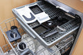 Dishwasher with various items inside, labeled 'Dishwasher Safe' and 'Just Load & Go'.
