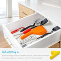 Set of kitchen utensils including spatulas and ladles in a drawer with text about space-saving design.