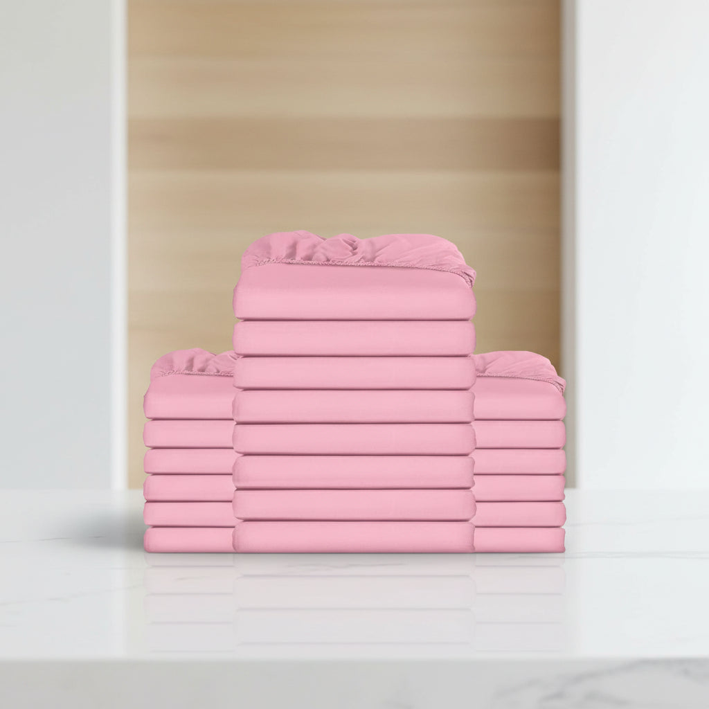 A stack of folded pink bedding sheets or duvet covers on a plain white background.