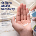 Hand holding a bottle of skincare product with text about skin sensitivity and defense.