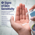 Hand holding a bottle of skincare product with text about skin sensitivity and defense.