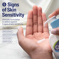 Hand holding a bottle of skincare product with text about skin sensitivity and defense.
