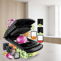 Black vegetable chopper with various attachments and chopped vegetables on a white background, featuring the brand 'fullstar'.