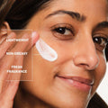 Woman applying cream to her face with text highlighting features
